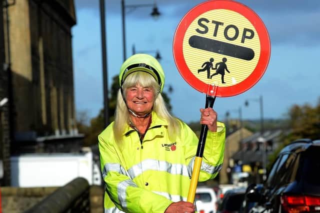 Irene Reid pictured with a commemorative lollipop after clocking up 50 years' service in Longridge - she has added another three since