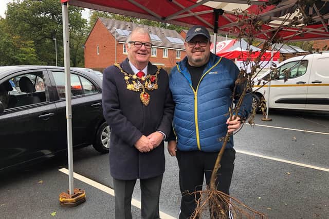A resident collects his tree from the Mayor of Chorley Councillor Steve Holgate.