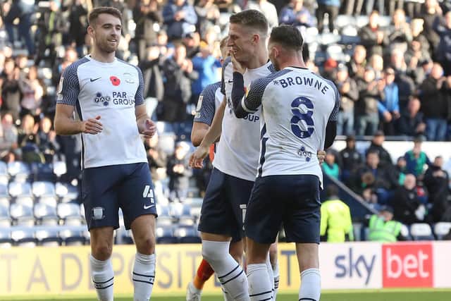 Preston striker Emil Riis (centre) is congratulated by captain Alan Browne and Ben Whiteman after converting from the spot