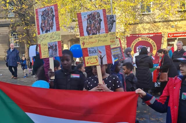 Children with the Sudanese flag in Market Square in Lancaster at a protest against the military coup in Sudan.