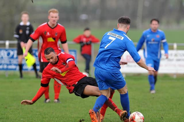 Longridge Town's Jordan Tucker with a sliding tackle