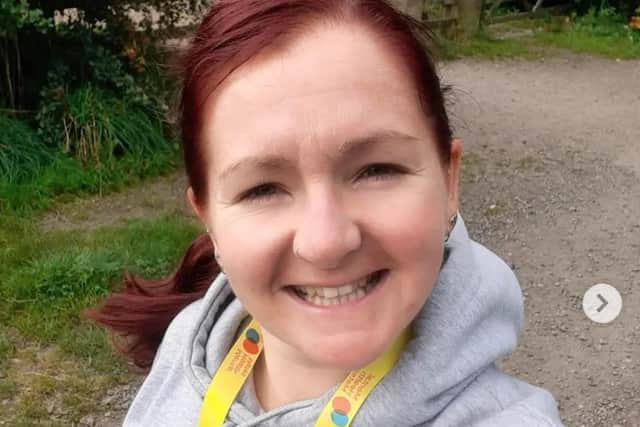 Siobhan out on one of her walks wearing her yellow Mental Health Mates lanyard.