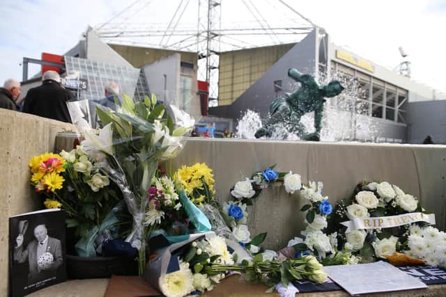 Floral tributes to Trevor Hemmings at the Splash statue at Deepdale