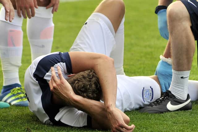 Calum Woods on the turf after damaging his knee at Oldham in July 2016