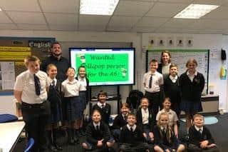 Pendle pupils campaigning for the return of a lollipop crossing a patrol to the busy A6  at Forton, near Garstang are pictured with headteacher Lorna Boase and form teacher Patrick Haley