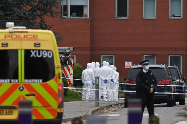 Police forensics officers work outside the Women's Hospital in Liverpool on November 15, 2021, the scene of yesterday's taxi explosion.