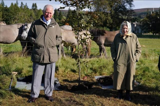 Her Majesty the Queen and Prince Charles planting a tree on the Balmoral Estate to signal the launch of the Queen's Green Canopy initiative last month.