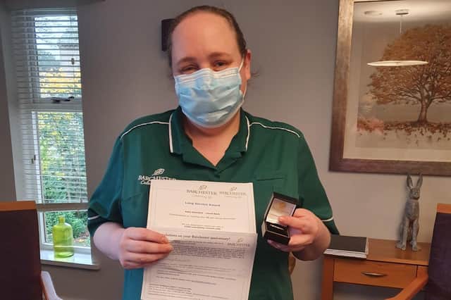 Health care assistant Kelly Stannard with her long service award from Laurel Bank care home in Lancaster.