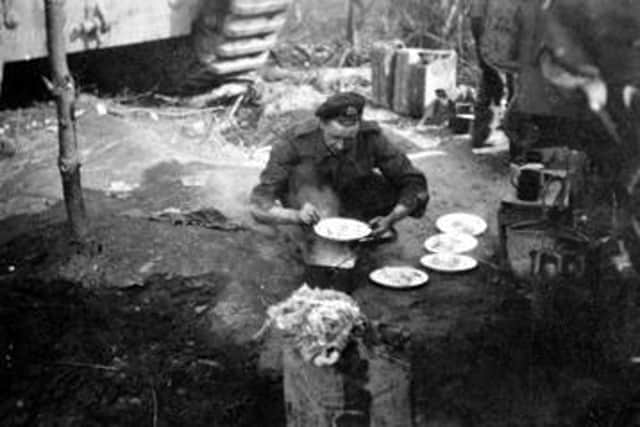 Lance Corporal Harry Higson of the 107th Regiment 'Dishing out the spuds' King’s Own Museum -Accession Number KO2775/04.