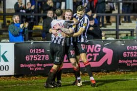 Will Tomlinson (centre) is congratulated by Connor Hall and Jacob Blyth after scoring against  Kettering Town (photo: Stefan Willoughby)