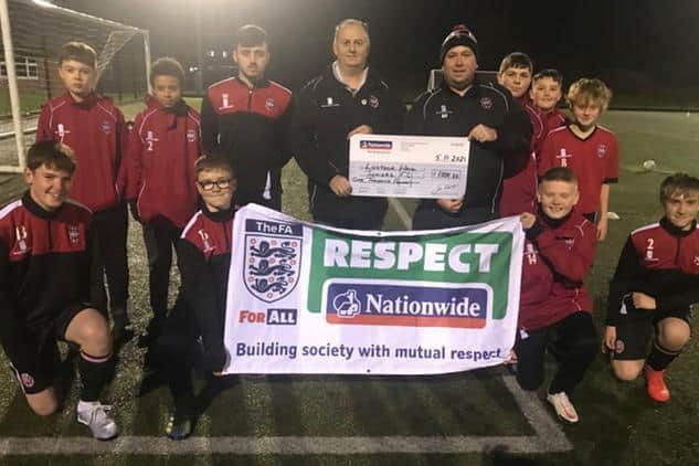 Lostock Hall Juniors Football team (Under 14 Stripes)  pictured receiving the £1,000 Respect cheque