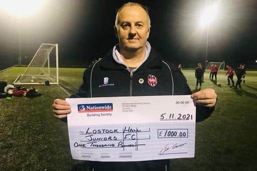 Club Chairman Darryl Cartwright pictured with the £1,000 cheque