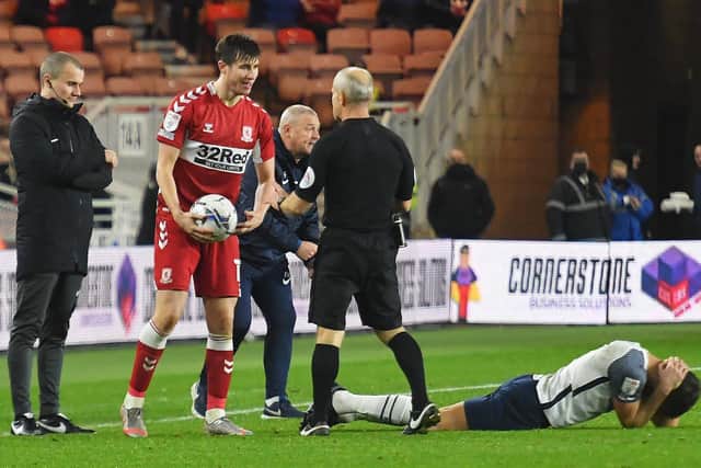 PNE substitute Ched Evans holds his head after a challengeas Frankie McAvoy looks on from the touchline.