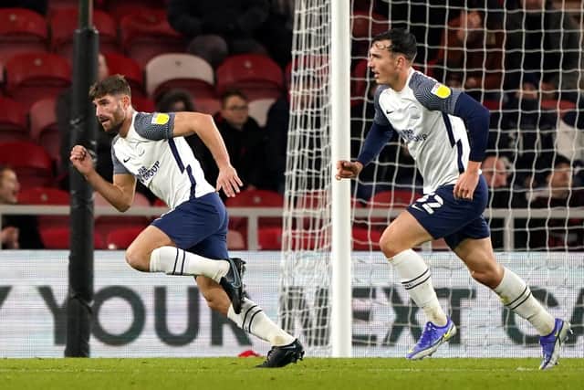Ched Evans turns to celebrate, pursued by Josh Earl, after scoring Preston North End's equaliser against Middlesbrough