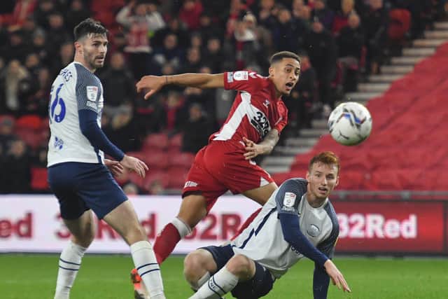 PNE defender Sepp van den Berg slides in to try and block a shot from Marcus Tavernier as Andrew Hughes watches on