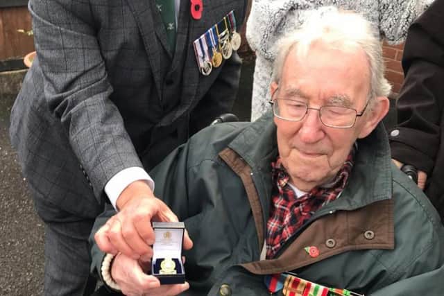 An emotional Len with his medals.