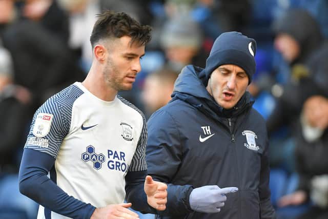 Preston North End defender Andrew Hughes leaves the pitch during the Fulham game with assistant physio Tim Horn