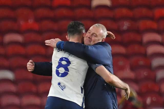 Alan Browne gets a hug from Frankie McAvoy after PNE's win at Middlesbrough