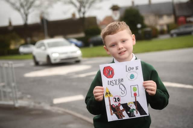 Seven-year-old pupil Evander Blyth with his road safety poster