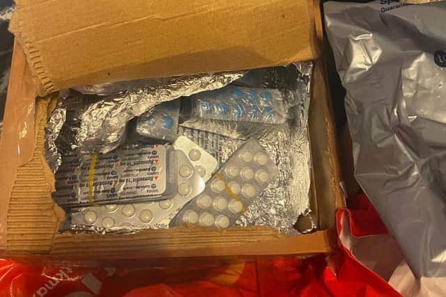 A large quantity of suspected prescription drugs were recovered from a second property in Blackburn (Credit: Lancashire Police)