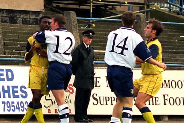 PNE's Simon Davey (No.12) steps in to calm things after Michael Holt (No.14) gets involved with Shrewsbury players