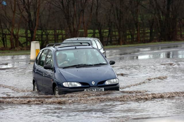 Cars negotiate the flood waters on Eastway, Fulwood, Preston