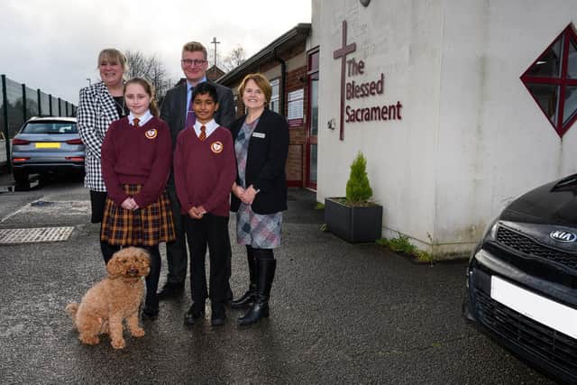 Miss Kelly Hannah, Mr Stuart Aris and Mrs Angela Morris with pupils Lilly Moran and Hirithik Ram Prasath and Buddy The Dog outside The Blessed Sacrament Catholic Primary School celebrating their OFSTED result. Photo: Kelvin Stuttard