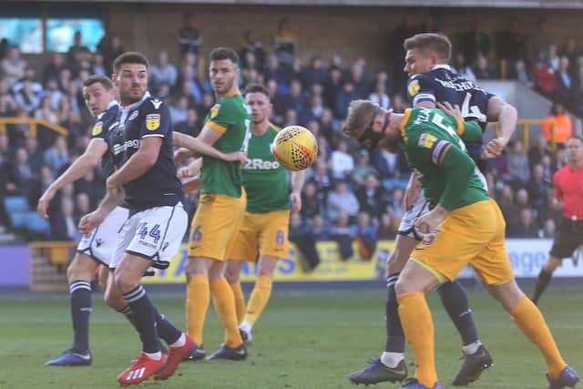 The masked Tom Clarke scores PNE's second goal at Millwall