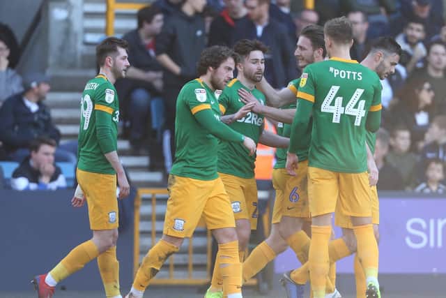 Sean Maguire is congratulated after scoring the third goal in PNE's win at Millwall in 2019
