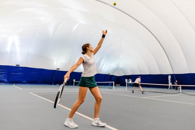 A Stonyhurst tennis player serving in the school's new Tennis Dome