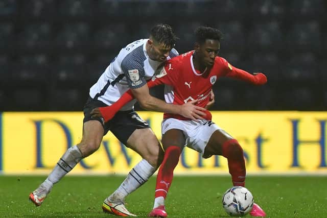 PNE's Andrew Hughes challenges Barnsley winger Clarke Oduor at Deepdale