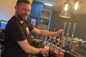 One of the owners of the bar Adam Smith mastering the art of a perfect pint.