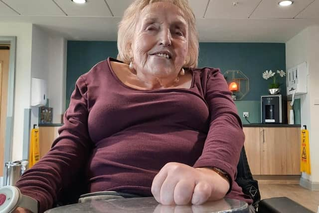 Elsie Longton pictured playing the drum during a music therapy session