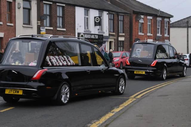 Two hearses arrive at All Saints Church for the double funeral.