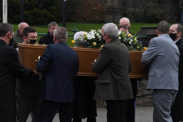 Pall bearers carry Anthony's coffin into church.