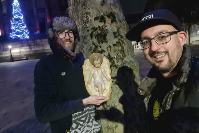 Michael Hopkins, owner of Miller Arcade burger and craft beer bar Smashed, and his manager Michael Evans, found the statue of baby Jesus next to a tree beside the Nativity cabinet in Flag Market, Preston late last night (Tuesday, December 21). Pic: Smashed