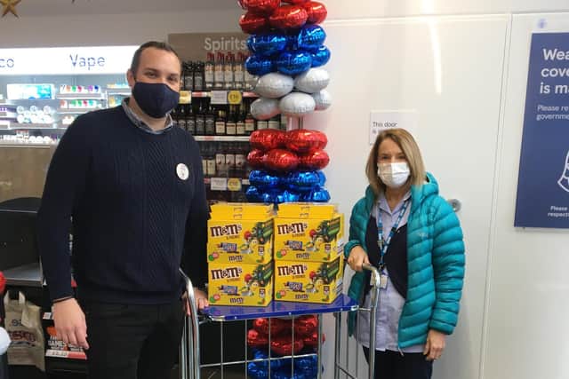 Store manager Andrew providing health care assistant Trish with some of the selection boxes.