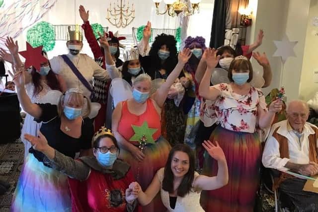 Panto performers adhering to Covid rules, with one lady exempt from wearing a mask.