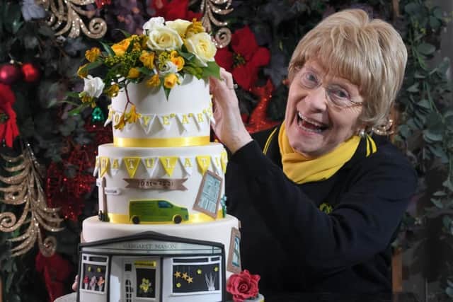 Margaret celebrated with a specially-made cake featuring her famous shop front.