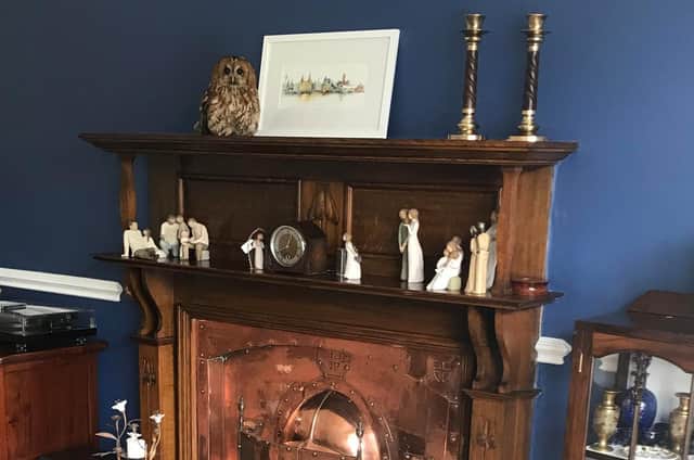 A couple from Southport had a shock when they heard a commotion coming from their living room and found a tawny owl sat on the fireplace!