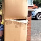 Seven-year-old Alex stood by three boxes of used crisp packets to be recycled through the Terracycle scheme