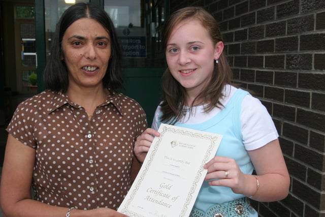 Vindi Tunney, principal at Greenhaw PS, presents a special Attendance certificate to pupil Nadine Barlow, who has achieved a 100% attendance record during her seven years at the school.  (0107T04).