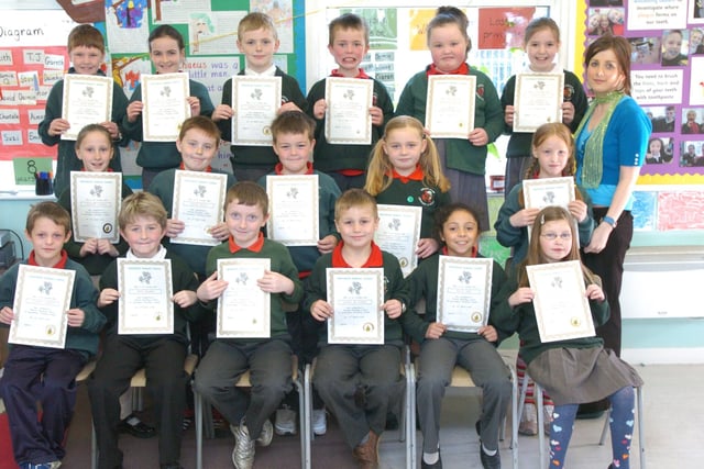 P4 pupils from Greenhaw Primary School receive certificates for completing a paired reading programme. Included is class teacher Ciara Mahon. (0505PG10)