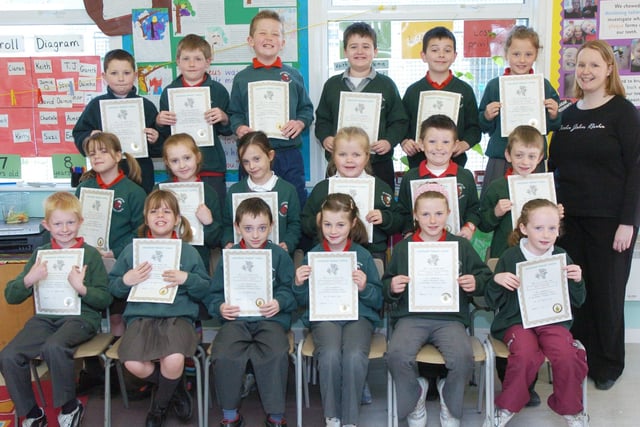 P4 pupils from Greenhaw Primary School receive certificates for completing a paired reading programme. Included is class teacher Sinead McFadden. (0505PG11)