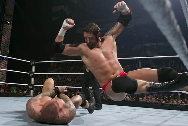 WWE Superstar Wade Barrett from Penwortham drops an elbow on Randy Orton during his in-ring days