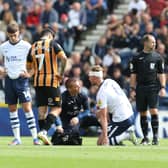 Preston North End's Liam Lindsay receives treatment to a head injury.