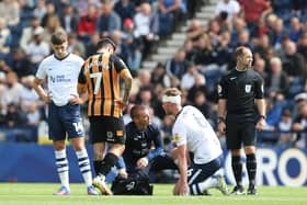 Preston North End's Liam Lindsay receives treatment to a head injury.