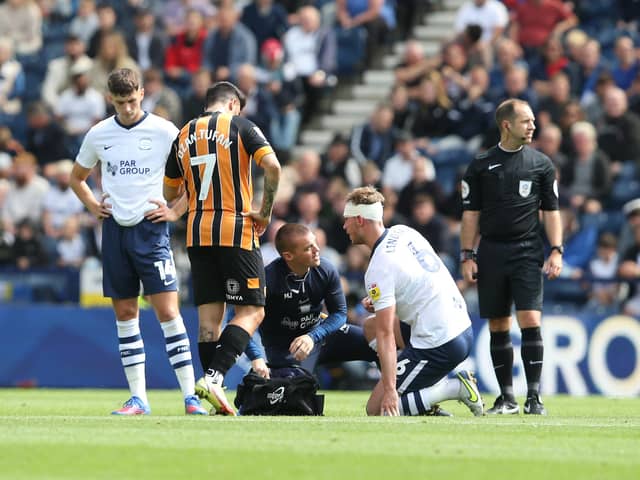 Preston North End's Liam Lindsay receives treatment to a head injury.
