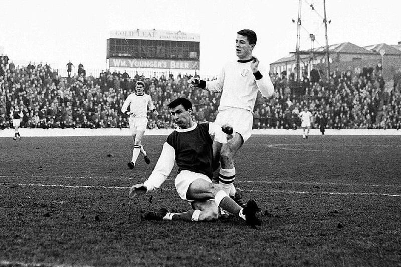 Joe Davis challenges Finn Dossing of Dundee United during a match at Easter Road in January 1965
