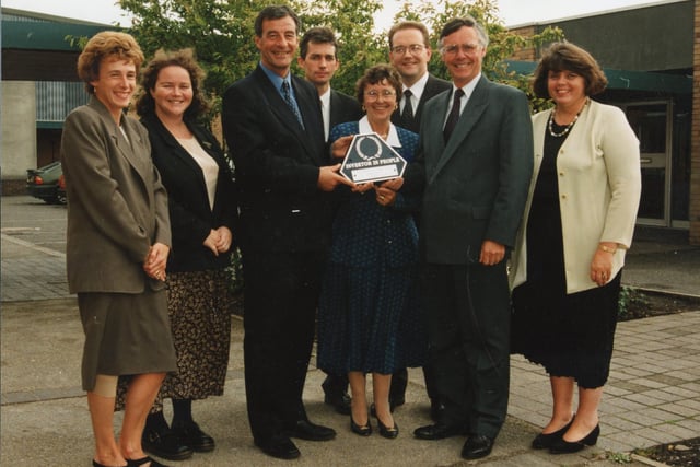 A Penwortham high school celebrated its 20th birthday by picking up a top award. All Hallows RC High is the first school in Preston and South Ribble to be recognised as an Investor in People. Picture shows managing director of LAWTEC Mr Mike Bickerstaffe (third from left) presenting the award to Pat Crean and Mike Flynn, with other members of the school's III working party in 1995
